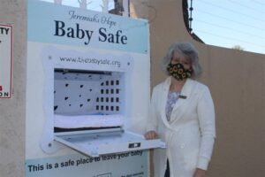 Sharon Rushton stands next to the baby box at the facility, intended for anonymous drop off of infants